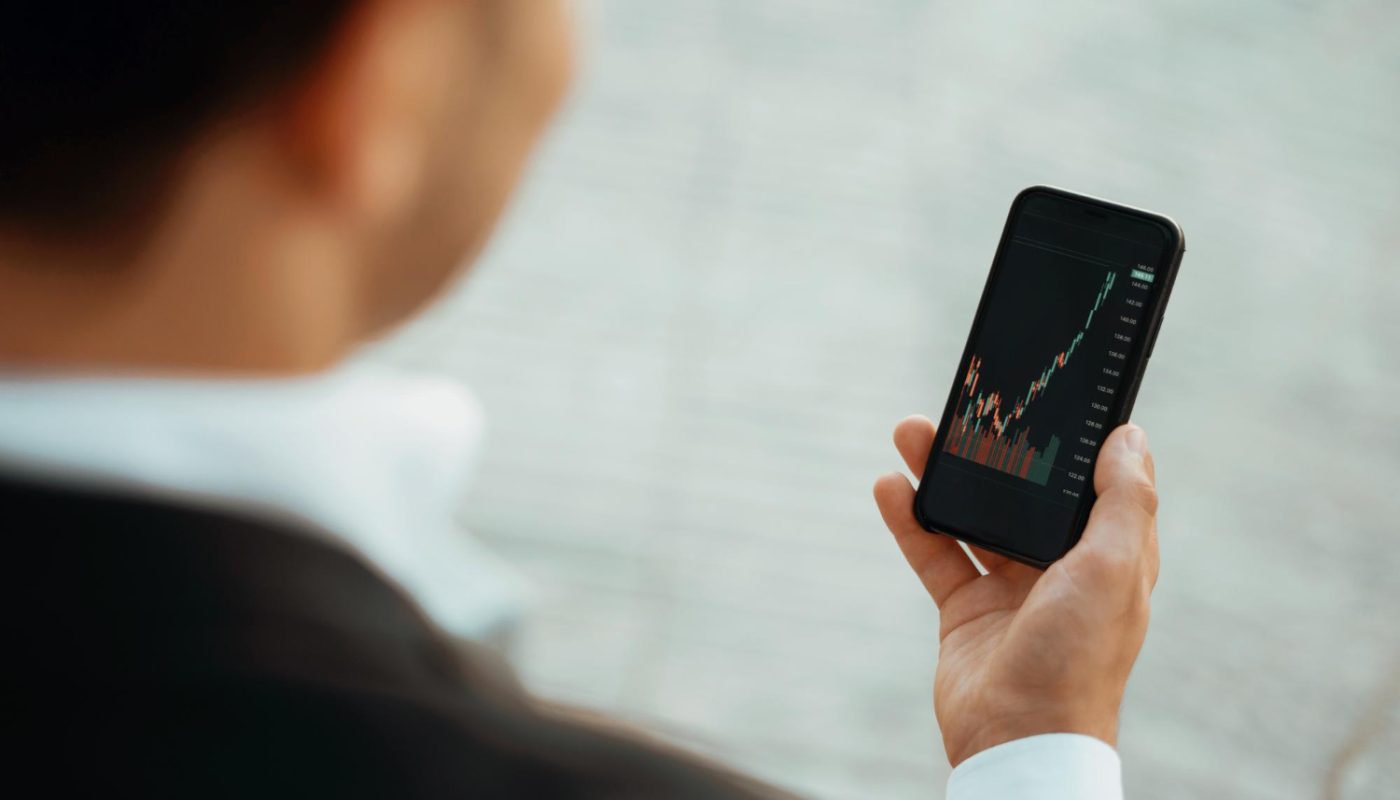 trader trades stock exchange his phone