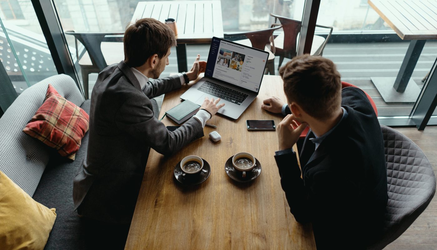 two guys discussing a seedhunter project while having a coffee