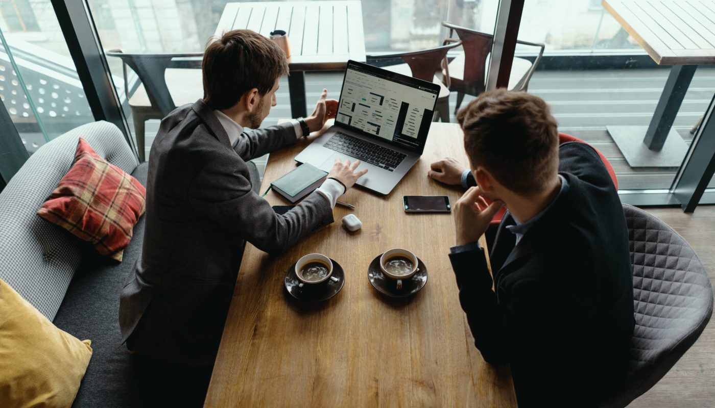 Two young businessman having a successful meeting at restaurant.